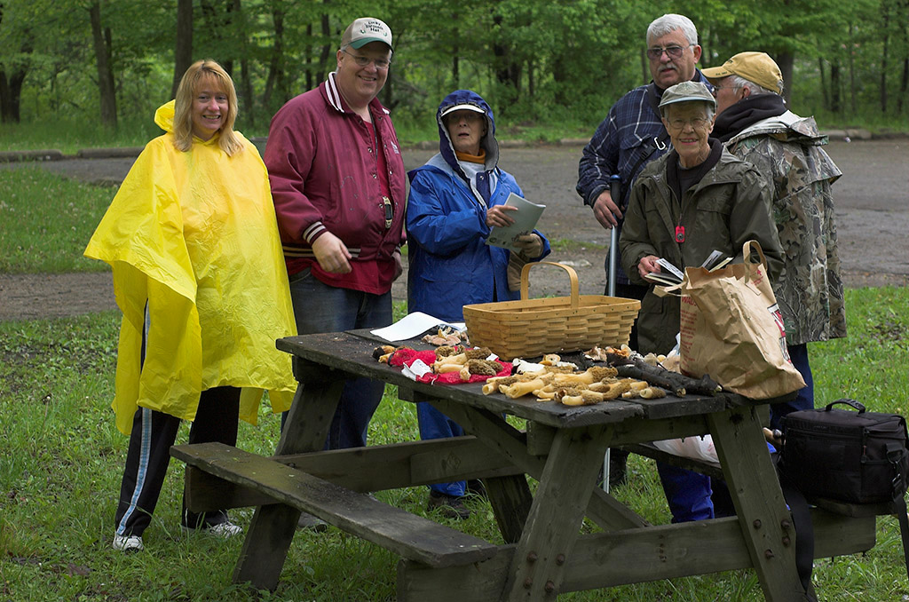 IMA members display fungal specimens found during a rainy survey.
